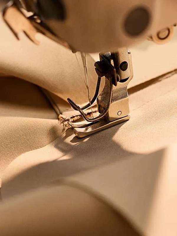 Industrial sewing foot stitching knit fabric for custom sportswear manufacturer workflow